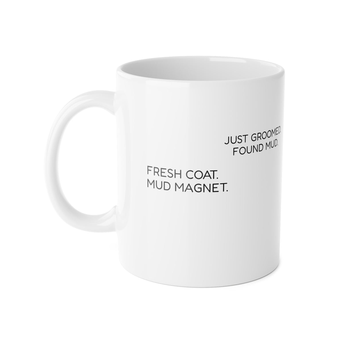 White ceramic mug showing the wraparound phrases ‘Just Groomed. Found Mud.’ and ‘Fresh Coat. Mud Magnet.’