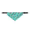 Fresh & Fluffy turquoise dog bandana with a colorful paw, brush, comb, bone, and bubble pattern on an adjustable black collar.